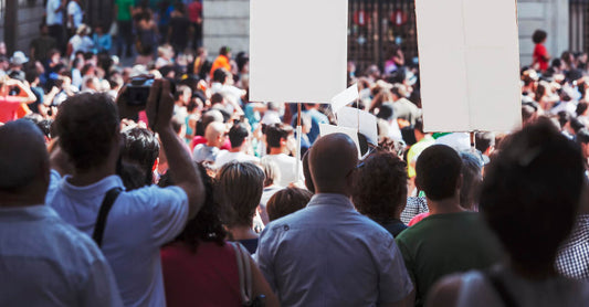 A crowd of people holding signs at a protest