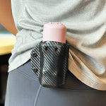 A close up of the AIIRO device in a holster being worn on someone's hip