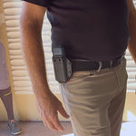 A close up of the AIIRO device being pulled from a holster on someone's hip